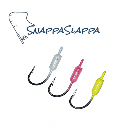 Three SnappaSlappa saltwater fishing jigs in silver, pink, and yellow colors.